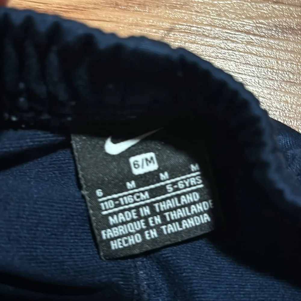 Size 6 Nike pants- blue with silver stripes. Athletic pants